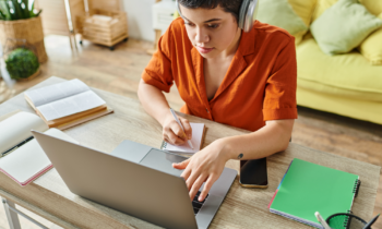 Attractive short haired woman with headphones doing transcription work from CrowdSurf