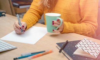 An EF Education First teacher, working on lesson plans at her home office desk.