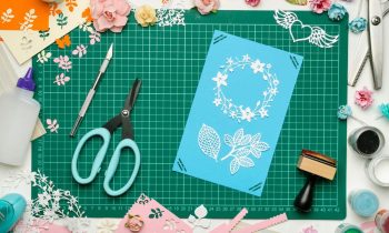 The home workspace of a Cricut crafter, making a handmade card.