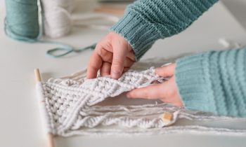 A closeup image of an Etsy seller making a macrame wall hanging.