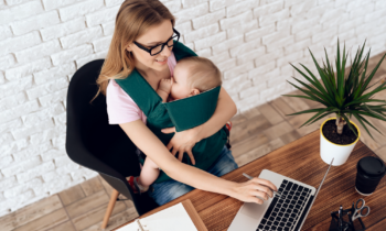 Mom working from home with baby in a sling learning how to avoid distractions