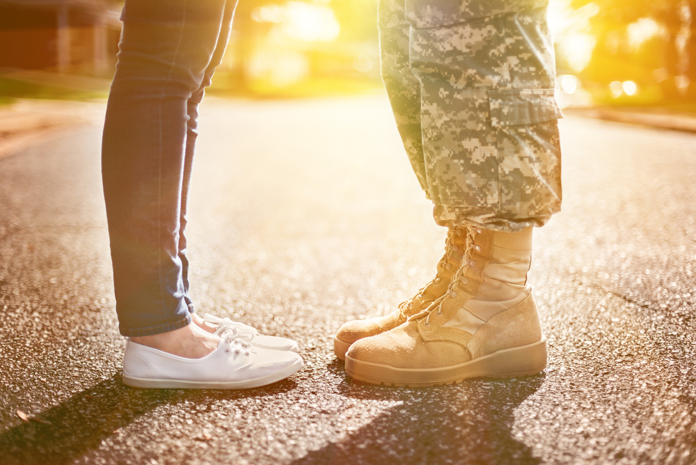 military couple standing in the street saying goodbye