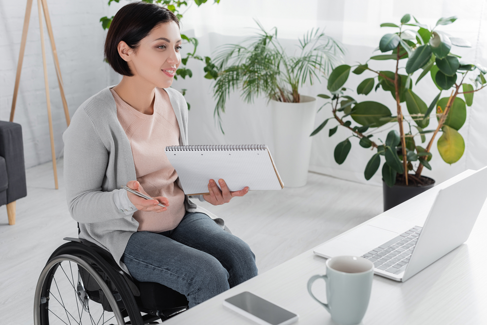 woman in a wheelchair working from home