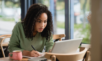 Young woman studying for a course in a cafe