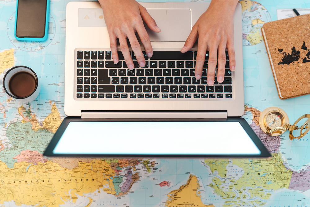 Woman working on a laptop as a wok from home travel agent