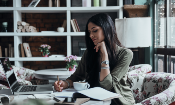 Woman writing in a notebook for the blog post finding your career path