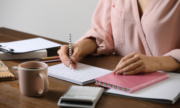 Woman working on her schedule for her personal concierge business.