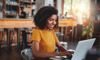 Young woman typing on laptop looking for work from home jobs that pay weekly