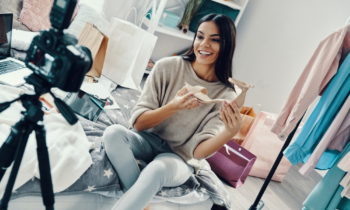 Young woman unboxing shoes for a social media video