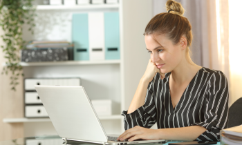 ebay seller working on laptop at home trying to figure out how to increase ebay sales